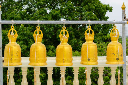 Sort golden bells hanging on a hangerの写真素材