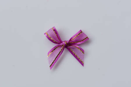 purple ribbon bow on white backgroundの写真素材