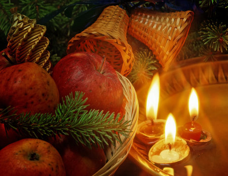 christmas still life with an apples and candles floating in plateの写真素材