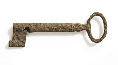 very old heavy rusty key isolated at whiteの写真素材