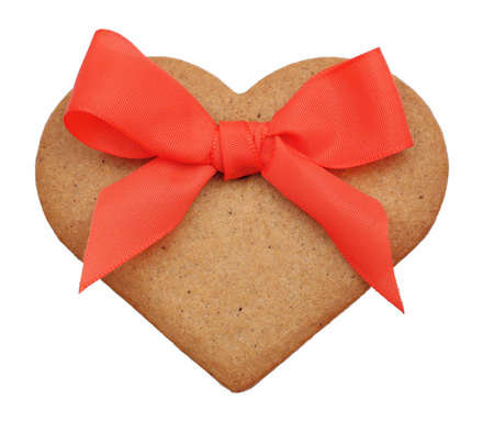 Christmas decoration - ginderbread heart with a red ribbonの写真素材
