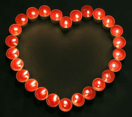 red tea candles in heart shapeの写真素材