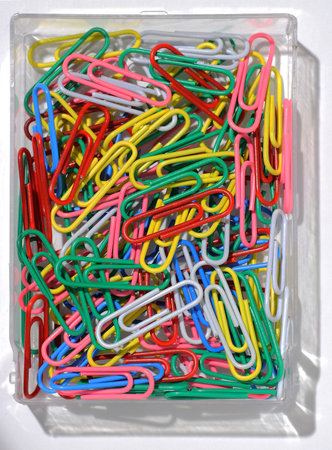 a set of color paperclips in plastic box