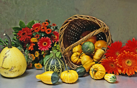 still life with basket of decorative calabash and flowers の写真素材