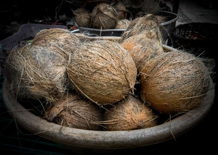 Collection of peeled coconuts for sale in the market.の写真素材