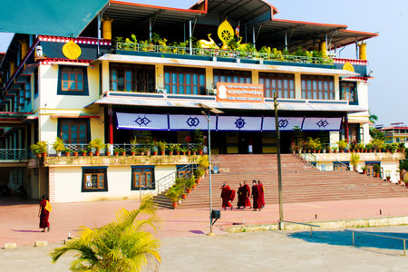 "Mundgod, Karnataka,India- 6th February 2022: Tibetan old monks in red color clothing wearing masks,walking on the infront of Buddhist monastery"のeditorial素材