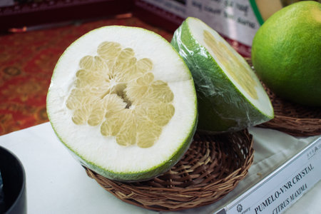 Fresh organic sliced Pomelo fruit(Citrus maxima) on a wicker basketの写真素材