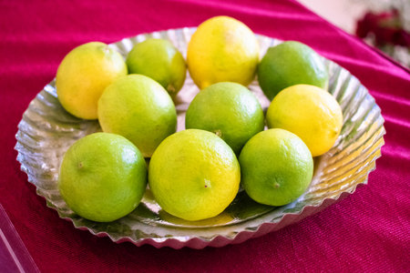 group of fresh lemons on a plateの写真素材