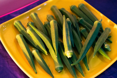 Fresh young okra on a plate,closeup shot.の写真素材