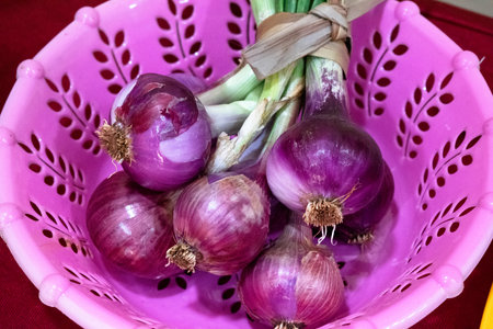 Fresh onions with scallions on a bowl.の写真素材