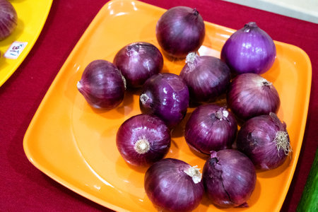 Fresh red onions on a plate.の写真素材
