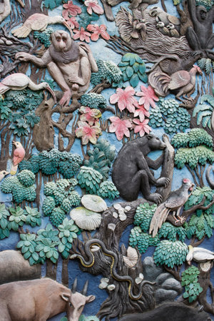 Animals stone sculpture on the wall in public park
