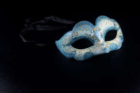 white blue glitter masquerade mask party isolated blackの写真素材
