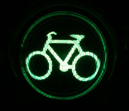 Green traffic light for bikers at nightの写真素材