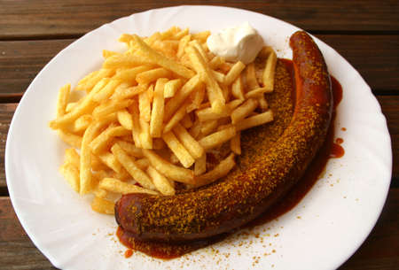 German Currywurst (Sausage with curry and ketchup) and French friesの写真素材