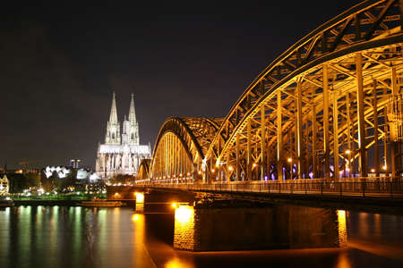 Illuminated Cologne dome, river Rhine and Deutz bridge at nightの写真素材