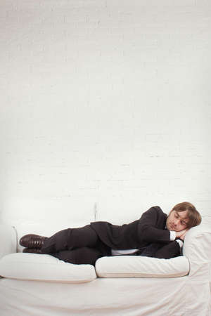 Man liying down on a couchの写真素材