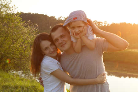 portrait of happy family in the park, mother, father and sonの写真素材