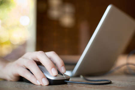 mouse click, woman hand with mouse and laptopの写真素材