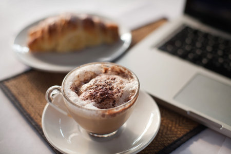 breakfast and internet, cup of coffee near laptop