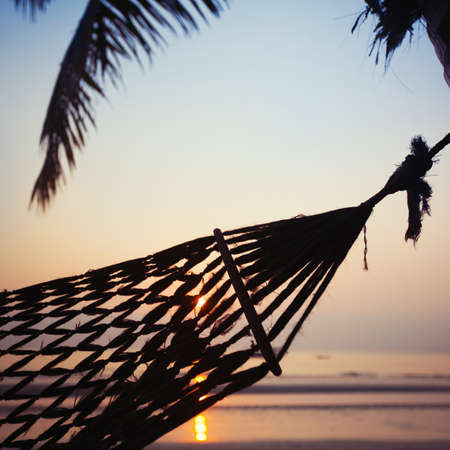 hammock at sunset, abstract vacations in tropicsの写真素材