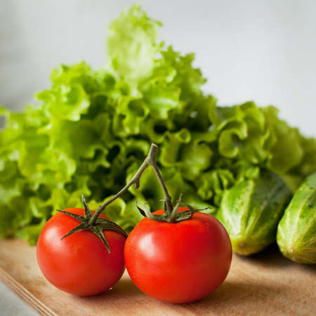 tasty tomatoes, cucumbers and salad on the kitchenの写真素材