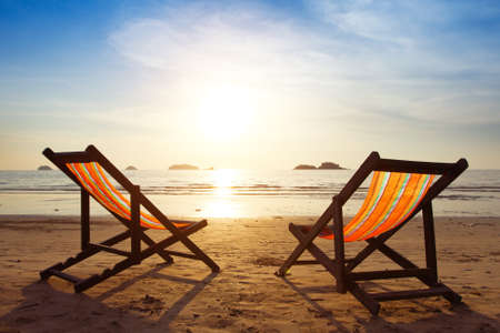 beach, two deck chairs and blue sky