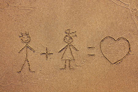 girl plus boy painted on the sandの写真素材