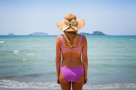 young blond woman enjoying the beach, backの写真素材