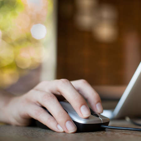 Female hand holding computer mouseの写真素材