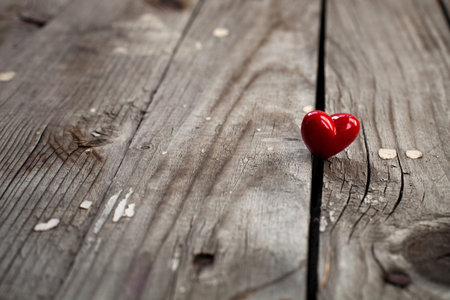 Valentines Day background with heart on wooden surface