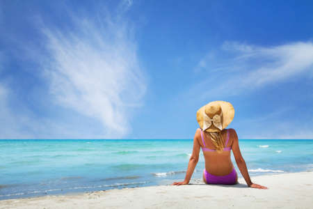 woman sitting on paradise beachの写真素材