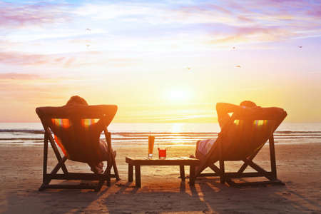 happy couple enjoy luxury sunset on the beach during summer vacationsの写真素材