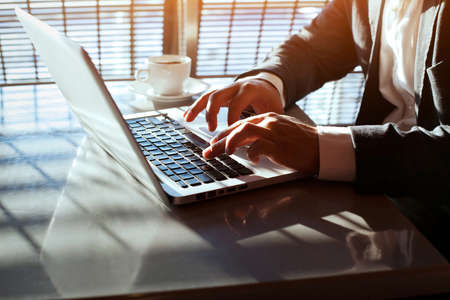 working on laptop, close up of hands of business manの写真素材