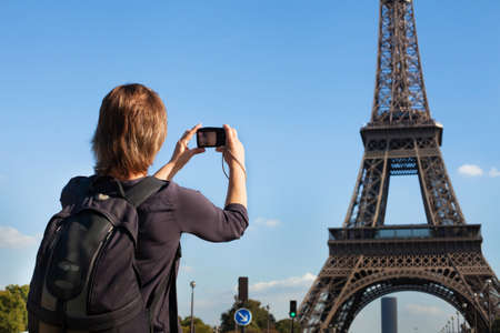 tourist in Paris, woman taking photo of Eiffel Towerの写真素材