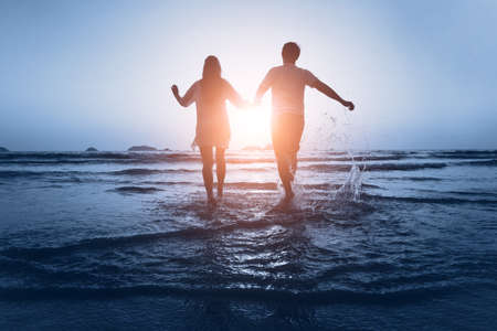 loving couple enjoy the sea at sunsetの写真素材