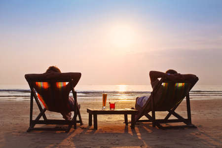 happy couple enjoy sunset on the beachの写真素材