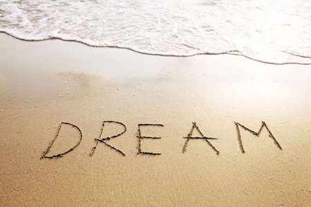 dream - word written on the beachの写真素材