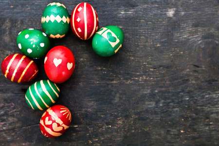 multicolored decorated easter eggs on wooden backgroundの写真素材
