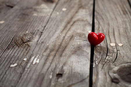 Valentines Day background with heart on wooden surfaceの写真素材