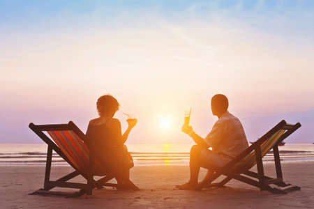family enjoying romantic sunset on the beachの写真素材