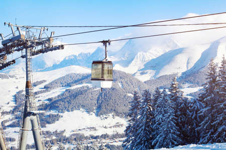 skiing in Alps, ski lift cabine and beautiful mountain panoramic landscapeの写真素材
