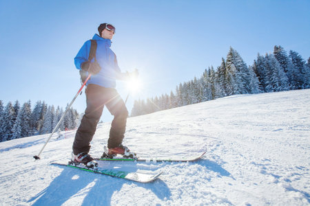 ski in Alps, winter sport, young skier on the slope in sunny dayの写真素材