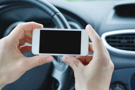using smartphone in the car for navigationの写真素材