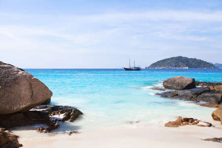 beautiful seascape, paradise island with sailing boat on horizonの写真素材
