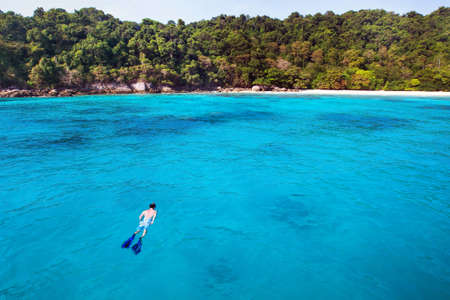 snorkeling background, swimming with mask and snorkel on paradise beachの写真素材