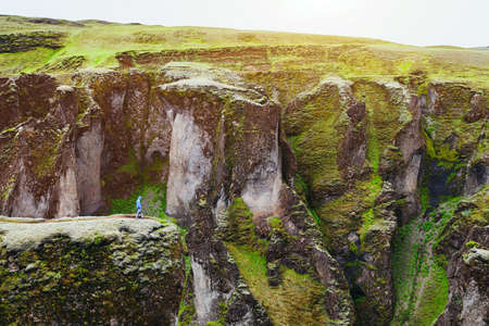 small person in huge landscape, traveler in big canyon in Icelandの写真素材