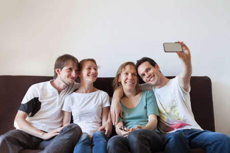 group of friends taking photo of themselves, home party, selfyの写真素材