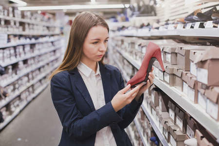 woman choosing shoes in the shopの写真素材