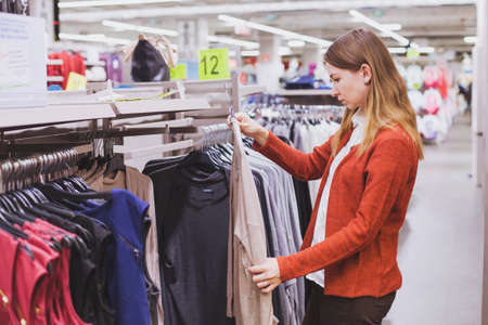 woman choosing clothes in the shopの写真素材